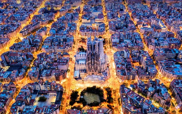 Aerial view of Sagrada Familia with surrounding city lights at night, 2K Desktop Wallpaper