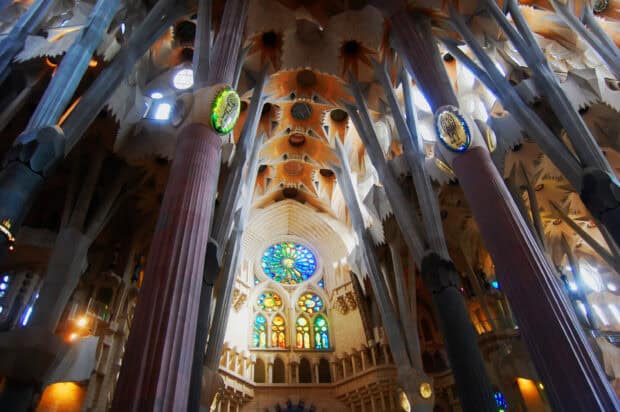 The Sagrada Familia interior showcases beautiful columns and colorful stained glass windows, 2K Desktop Wallpaper