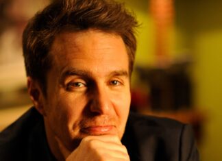 Sam Rockwell gazes thoughtfully with warm lighting, 2K Desktop Wallpaper