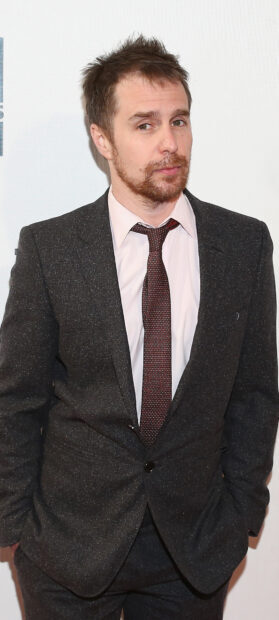 Sam Rockwell is wearing a dark checkered suit and tie while posing at an event, HD Mobile Wallpaper