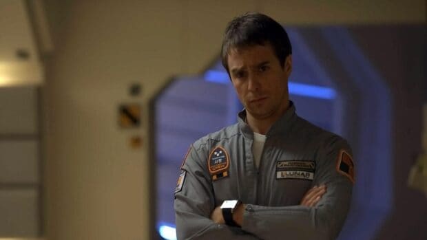 Sam Rockwell stands with arms crossed wearing a gray uniform with patches, HD Desktop Wallpaper