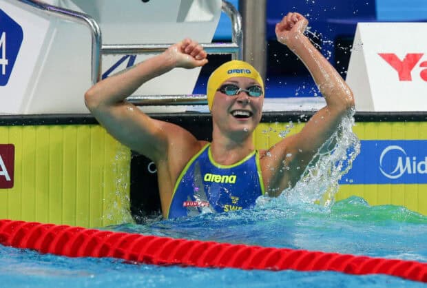 Sarah Sjostrom celebrating a swimming victory in the pool with arms raised, HD Desktop Wallpaper