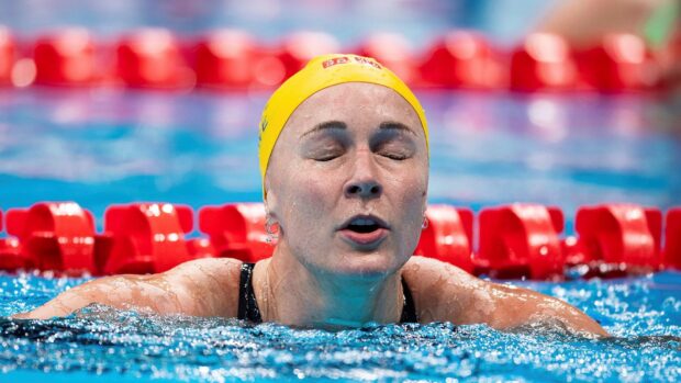 Sarah Sjostrom is shown swimming with determination in a pool during a race, HD Desktop Wallpaper