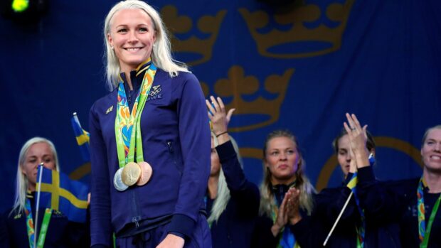 Sarah Sjostrom proudly displaying her Olympic medals on stage, HD Desktop Wallpaper