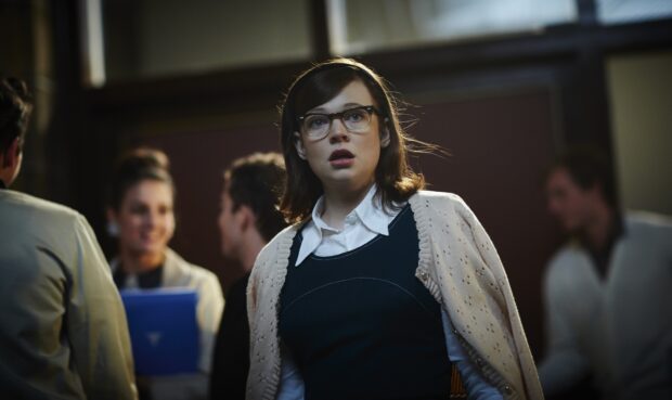 Sarah Snook is shown with glasses and a sweater in a crowded room, HD Desktop Wallpaper