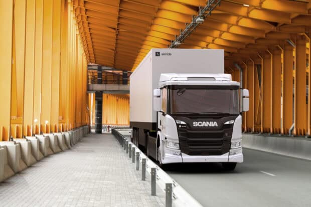 A white Scania truck is driving inside an orange tunnel with metal beams and a tiled path, HD Desktop Wallpaper