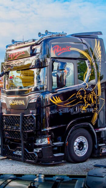 A black Scania truck features a golden eagle graphic and red lettering on the side panel, 4K Mobile Wallpaper