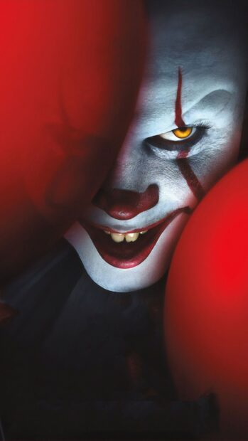 A close up of a scary clown face with white makeup and red balloons, 2K Mobile Wallpaper