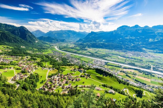 A stunning view of a valley and mountains with a small town in Liechtenstein wallpapers, HD Desktop Wallpaper