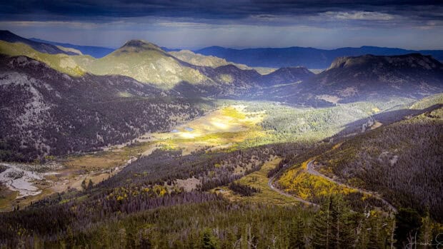 A scenic view of Rocky Mountain National Park with lush forests and winding roads, 4K Desktop Wallpaper