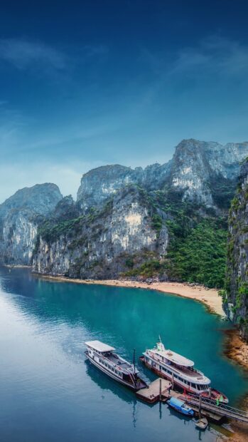 A tranquil bay with boats and limestone cliffs illustrates Vietnam wallpapers beautifully, 4K Phone Wallpaper