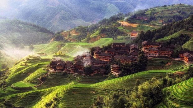 A village surrounded by terraced fields and mountains with green vegetation, HD Desktop Wallpaper