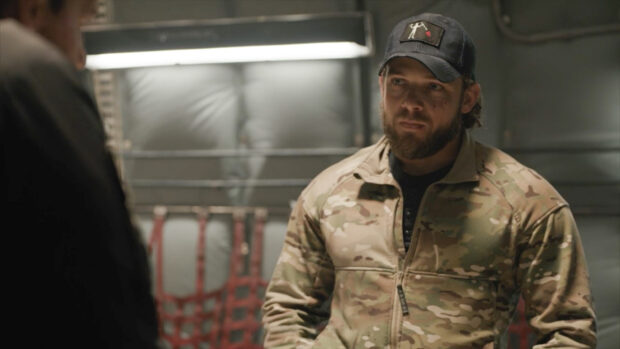A soldier from Seal Team tv series wears tactical gear and a cap during a mission briefing, HD Desktop Wallpaper