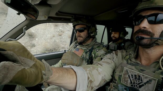 Three Seal Team members wear tactical gear and communicate inside a military vehicle, HD Desktop Wallpaper