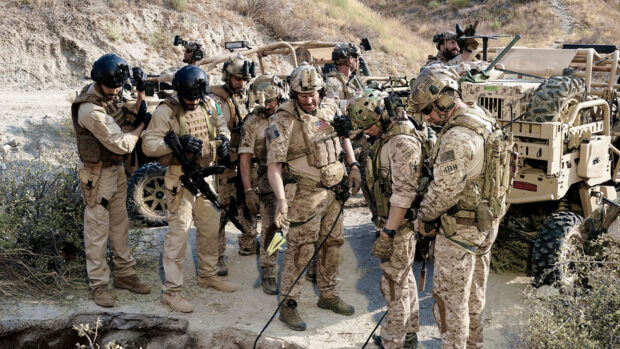 A Seal Team is shown preparing and coordinating before a tactical operation in a desert terrain, HD Desktop Wallpaper