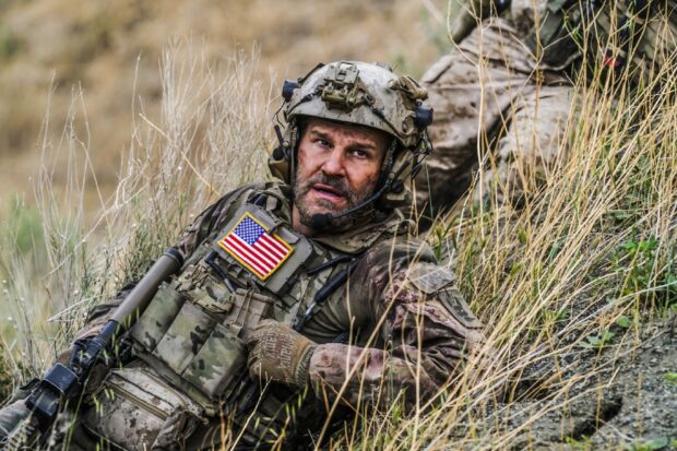 A Seal Team member communicates during a mission in rugged terrain from Seal Team Tv Series Wallpapers, HD Desktop Wallpaper