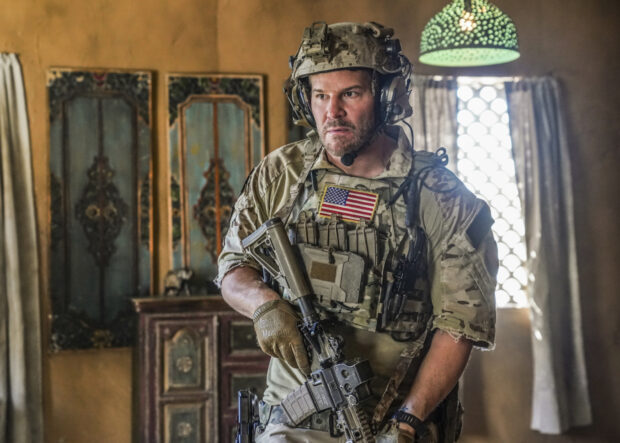 A Seal Team soldier cautiously moves indoors with a rifle ready during a mission, HD Desktop Wallpaper