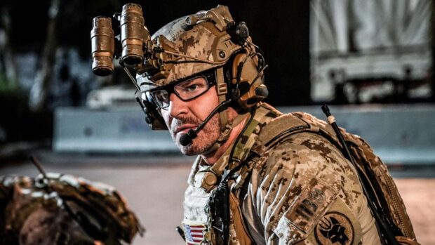 A Seal Team member is shown wearing tactical gear and communicating during a mission, HD Desktop Wallpaper