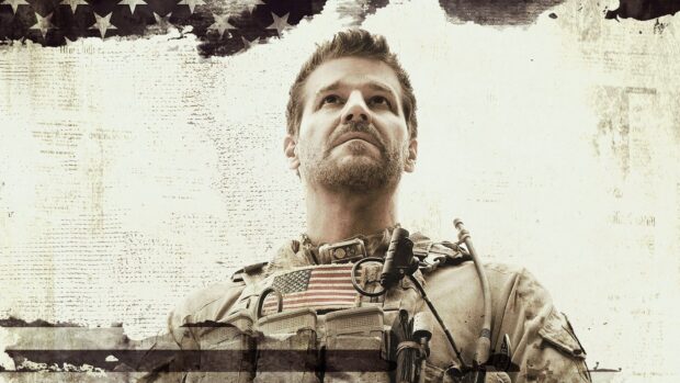 A Seal Team soldier in tactical gear looks determined in front of a faded American flag background, HD Desktop Wallpaper