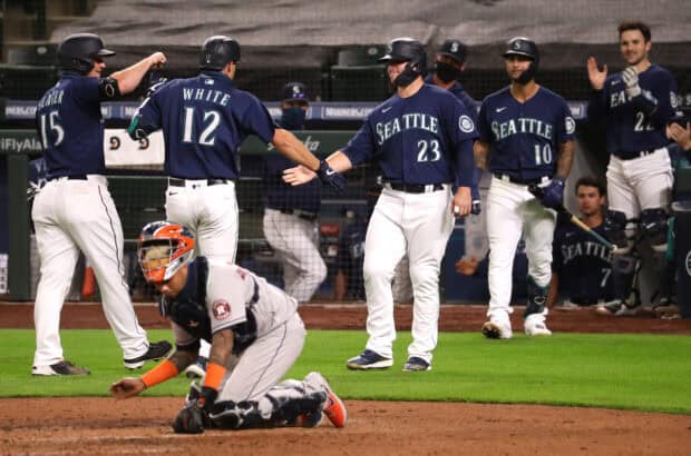 Seattle Mariners players celebrating on the field after a score during a game, 2K Desktop Wallpaper