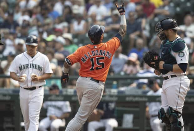 A Seattle Mariners player scores as the catcher and pitcher react during the baseball game, 2K Desktop Wallpaper