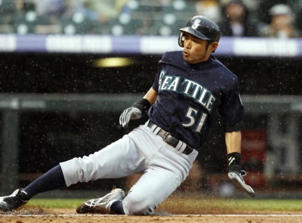A Seattle Mariners player slides into base during a rainy game, HD Desktop Wallpaper