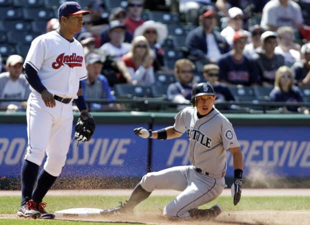 A Seattle Mariners player slides into base while a Cleveland Indians player stands nearby during the game, HD Desktop Wallpaper