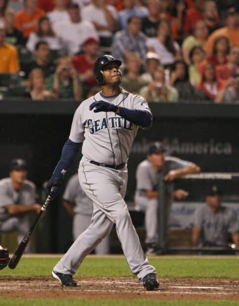 A Seattle Mariners player swings the bat during a baseball game with spectators watching, 2K Desktop Wallpaper