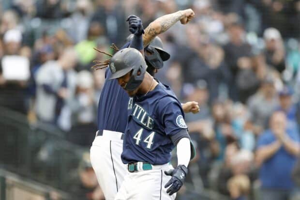 Two Seattle Mariners players are celebrating a successful moment on the baseball field, 2K Desktop Wallpaper