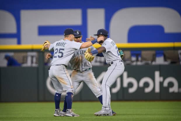 Three Seattle Mariners players share a joyful moment during a baseball game, 2K Desktop Wallpaper