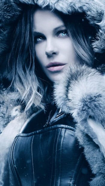 Selene underworld is wearing a fur lined hooded coat in a snowy setting, 4K Mobile Wallpaper