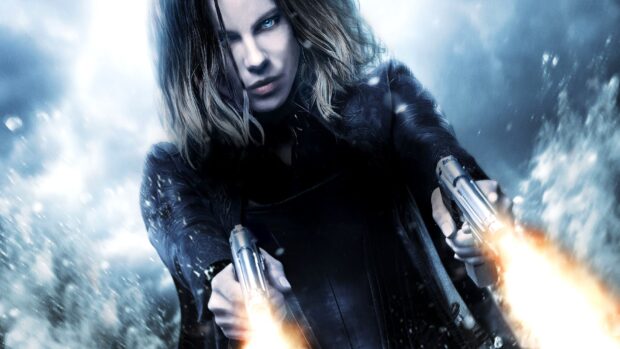Selene fires two guns intensely in a dark snowy environment, HD Desktop Wallpaper