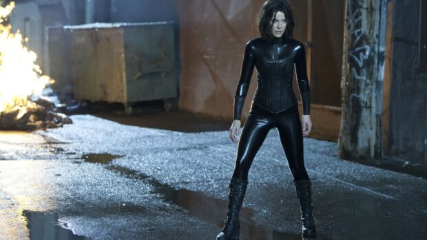 Selene stands confidently in a black outfit in a dimly lit alleyway, HD Desktop Wallpaper