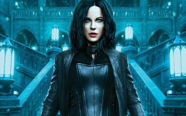 Selene stands confidently in a dark gothic castle with glowing blue lights and stairs, HD Desktop Wallpaper