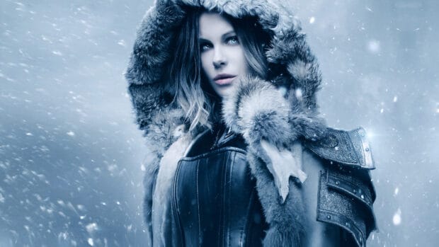 Selene is standing in a snowy environment wearing fur and leather armor, 2K Desktop Wallpaper