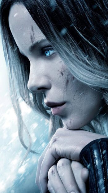 Selene underworld wallpapers shows a close up of a determined woman with blue eyes and scratches, 4K Phone Wallpaper