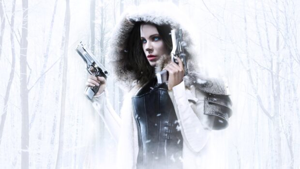 A warrior Selene stands in a snowy forest holding dual pistols with intense focus, HD Desktop Wallpaper