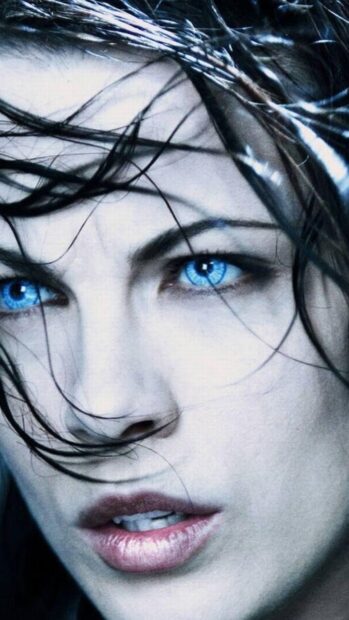 A close up of Selene with intense blue eyes and wet hair in an Underworld scene, 4K Mobile Wallpaper
