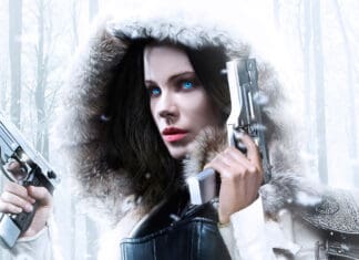 A fierce woman with blue eyes holding two guns in a snowy forest scene of Selene Underworld, 2K Desktop Wallpaper