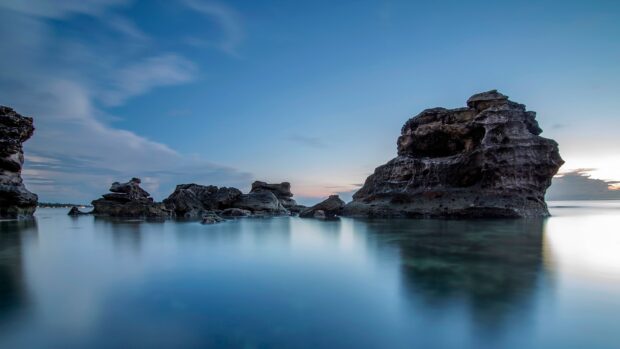 A calm seascape with rocky formations under a blue evening sky featured in Vietnam Wallpapers, HD Desktop Wallpaper