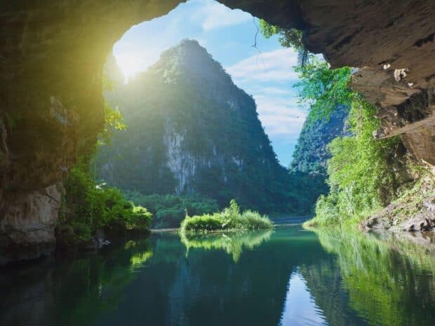 A peaceful river flows through lush mountains in Vietnam Wallpapers under bright sunlight, HD Desktop Wallpaper