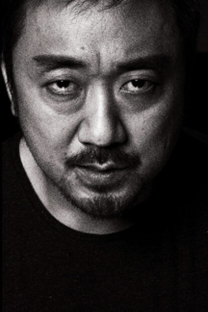 A black and white close up portrait of Ma Dong Seok showing a serious expression, 2K Phone Wallpaper