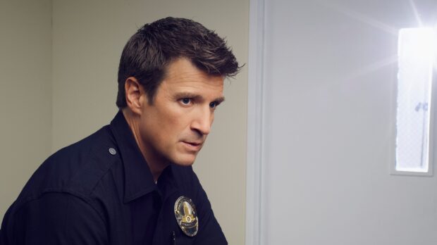 A man in a police uniform looks focused inside a room in The Rookie Tv Series, 2K Desktop Wallpaper