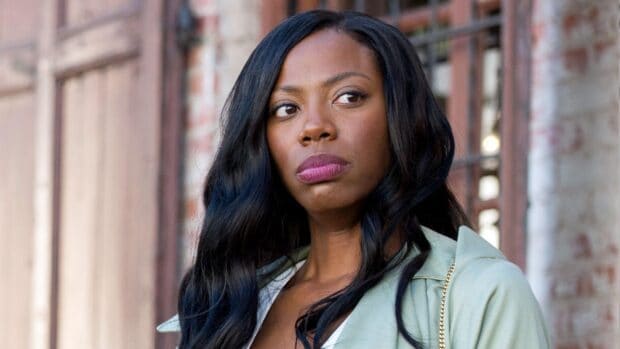 A woman with long black hair looks thoughtfully to the side in a city setting in Insecure tv series, HD Desktop Wallpaper