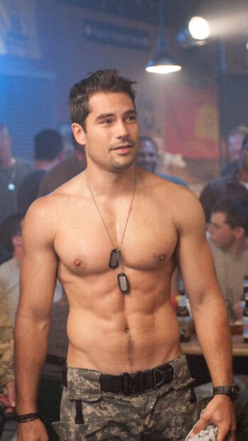 A shirtless soldier wearing dog tags stands in a crowded bar scene from the Gi Joe movie, HD Mobile Wallpaper