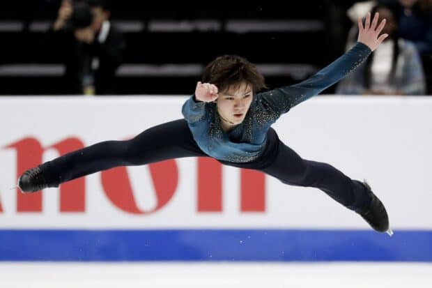 Shoma Uno performs a powerful leap during a figure skating routine, HD Desktop Wallpaper