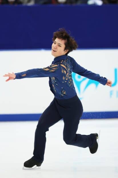 Shoma Uno is performing a dynamic move on ice in a blue costume, HD Phone Wallpaper