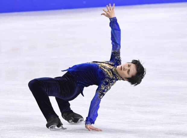 Shoma Uno performs a complex move on the ice during a competition, HD Desktop Wallpaper