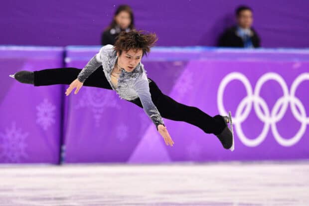 Shoma Uno is captured mid air during a figure skating routine, HD Desktop Wallpaper