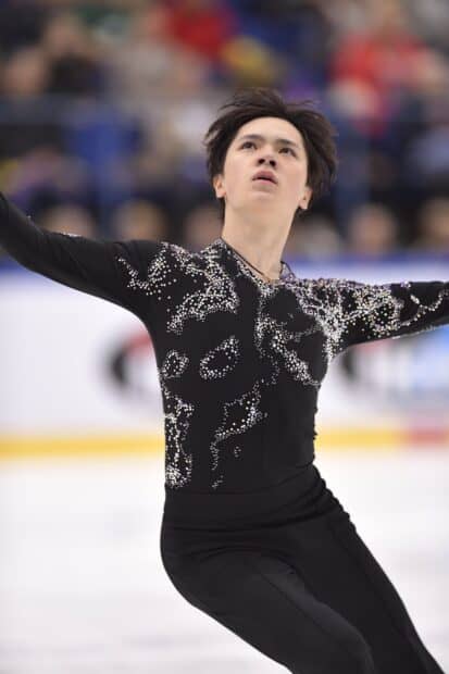 Shoma Uno performing a graceful ice skating routine with intense focus, HD Mobile Wallpaper